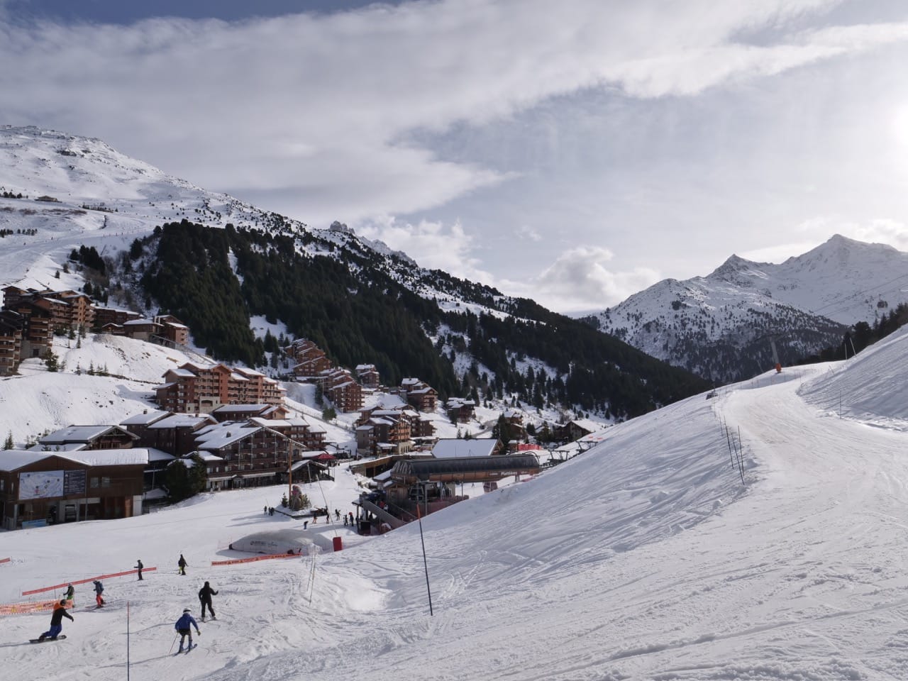 mountain, homes covered in snow, skiers